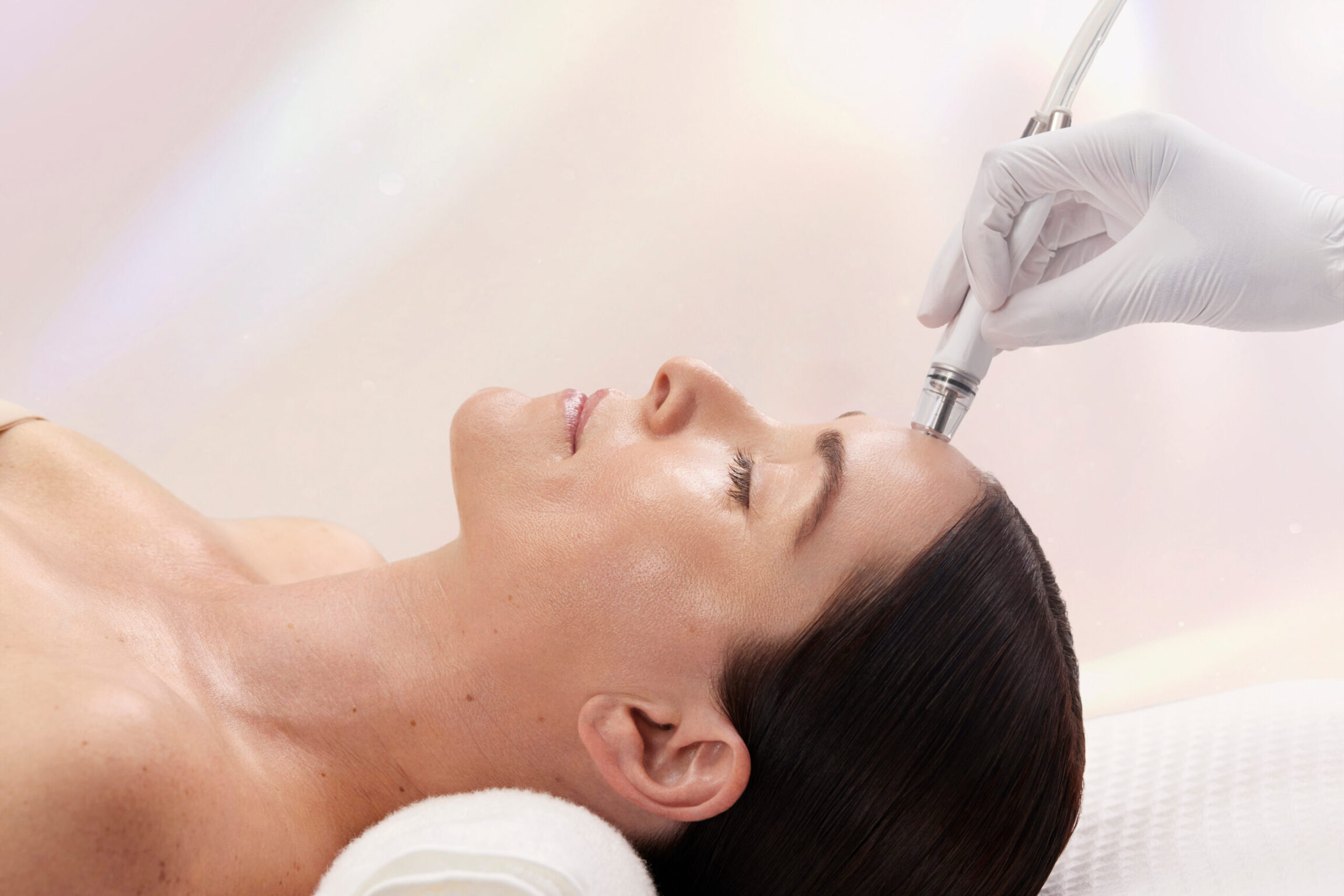 Patient receiving DiamondGlow facial for dull skin