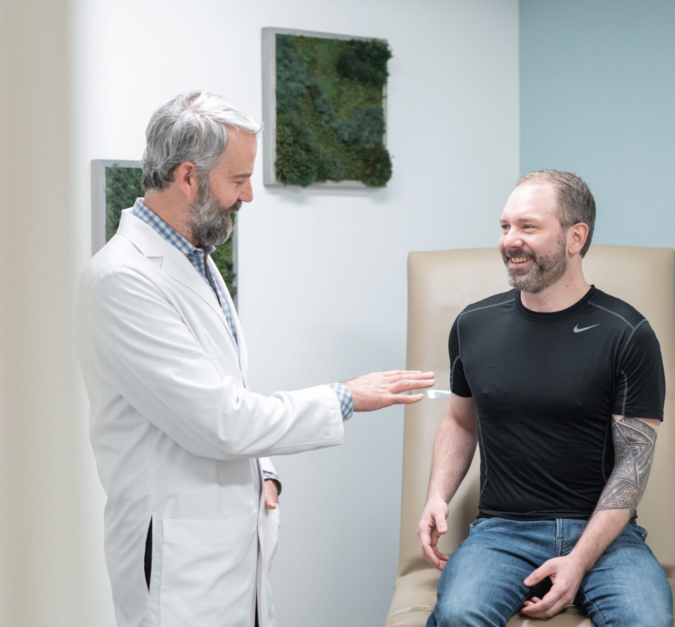 Dr. Donaldson discussing male breast reduction surgery options with a patient