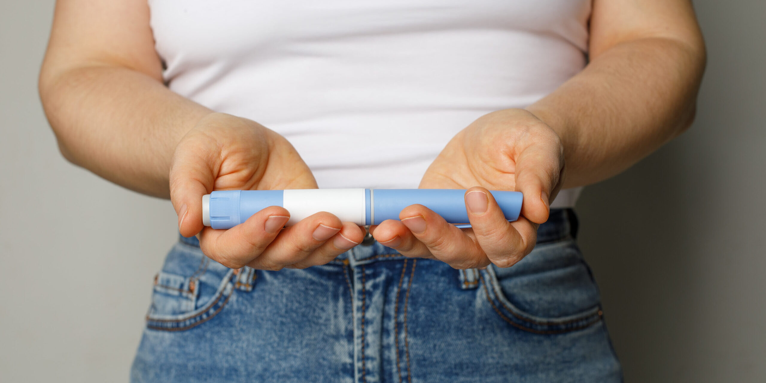 A patient holding their Ozempic weight loss medication 